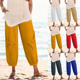 Pantalon féminin pour femmes plus taille Pantaire de taille élastique de couleur unie de mode avec de la jambe de harem lâche de poche