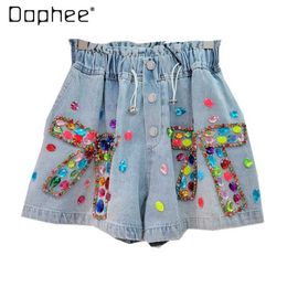 Dames shorts 2024 Zomer Europese goederen Nieuwe zware industrie Boog ingelegde kleur diamant kralen hoge taille afslanke brede denim shorts vrouwen y240420