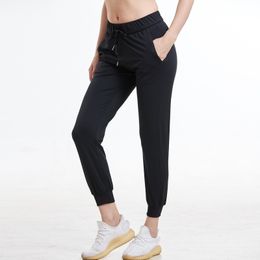 Femmes Tissus extensibles Coupe ample Sport Leggings skinny actifs avec deux poches latérales Pantalon à la cheville 201119