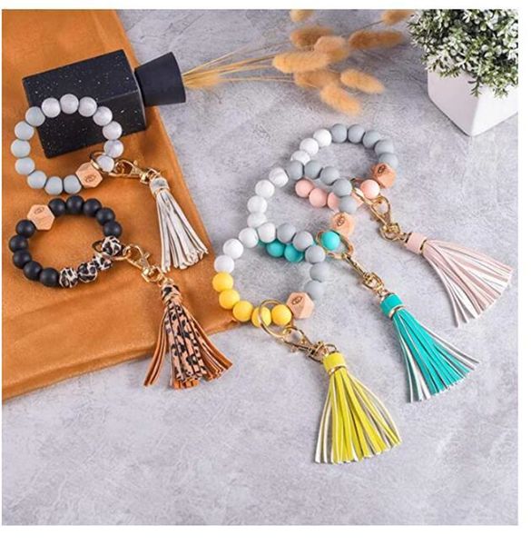 Pulsera de cuentas de madera Llavero Mujer Chica Favor de cuentas muñeca llavero Llavero de silicona para llaves Bolso de borla Encantos de coche Colgante Joyería Regalo de fiesta Llavero