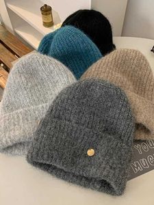 Chapeau en laine pour femmes et hiver édition coréenne Big Band Band Bounget tricot empilé pour petit visage chaud et épais chapeau de protection de l'oreille