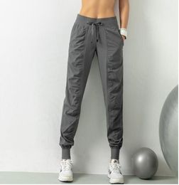 Yoga LL Pantalons de sport respirants Vêtements de sport Joggeurs pour femmes Séchage rapide Slim Entraînement de course en vrac Leggings de fitness Poche à neuf points Pantalons décontractés lu