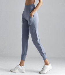 Trajes de yoga de entrenamiento de cintura alta Joggers Pantalones Mujeres Pantalones de chándal Fitness de tela desnuda con dos bolsillos laterales para 32333831